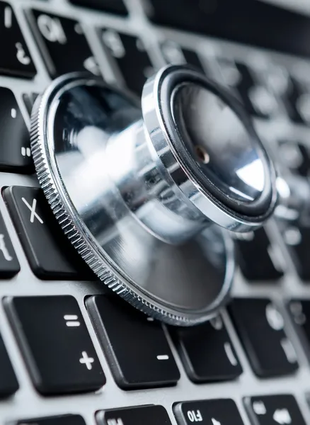 Close up of stethoscope on laptop keyboard — Stock Photo, Image