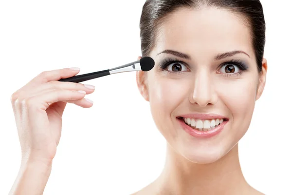 Woman putting on makeup with cosmetic brush — Stock Photo, Image