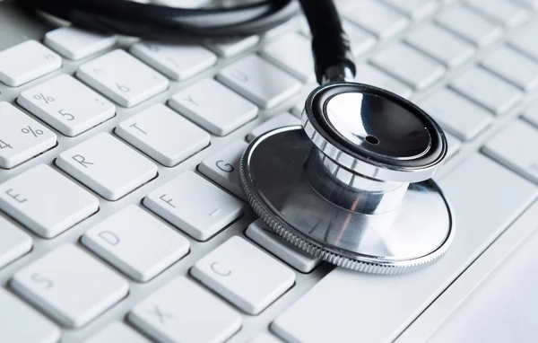 Close up view of stethoscope on computer keyboard — Stock Photo, Image