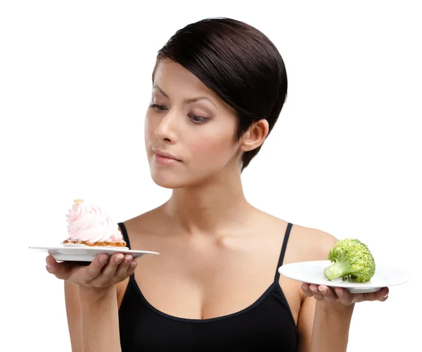 Doubting between cake and broccoli — Stock Photo, Image