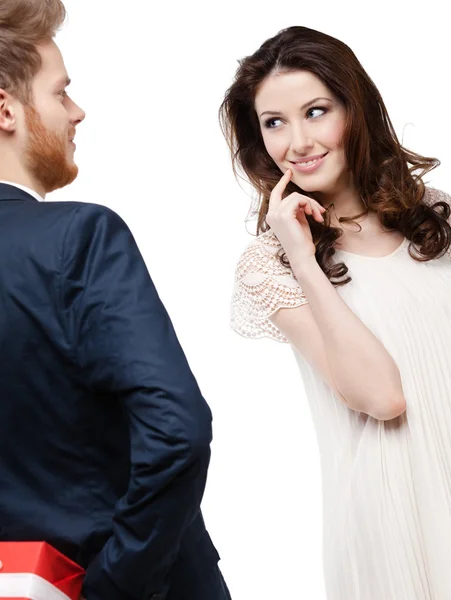 Young man hides the present behind the back — Stock Photo, Image