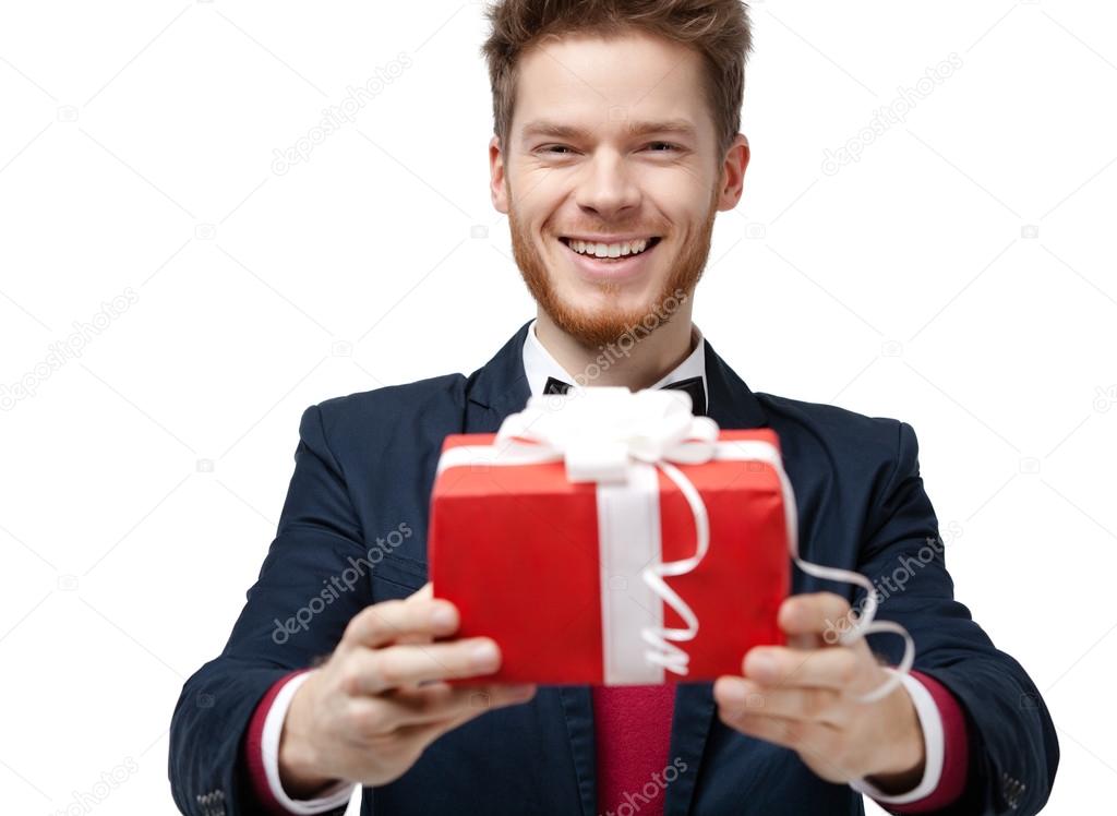 Smiley handsome man offers a gift