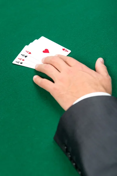 Hand with aces on the green table — Stock Photo, Image