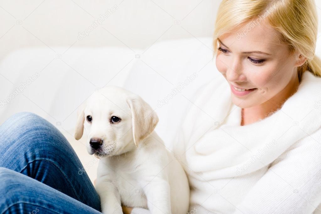 Close up of woman with puppy on her knees