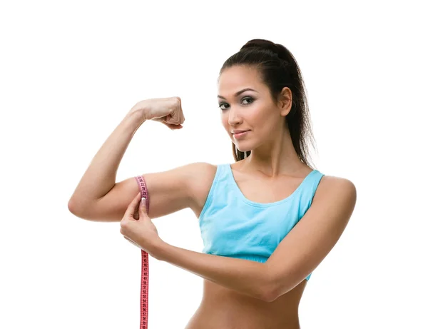 Mulher desportiva mede seu bíceps — Fotografia de Stock