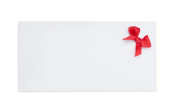 Envelope with red ribbon bow — Zdjęcie stockowe