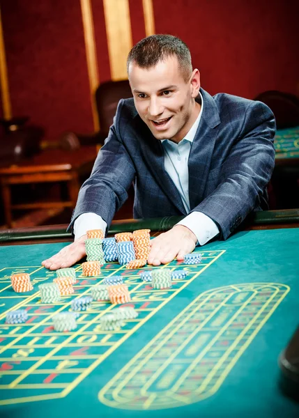 Gambler stakes playing roulette — Stock Photo, Image