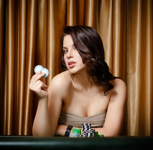 Female gambler at the casino table with chips — Stock Photo, Image