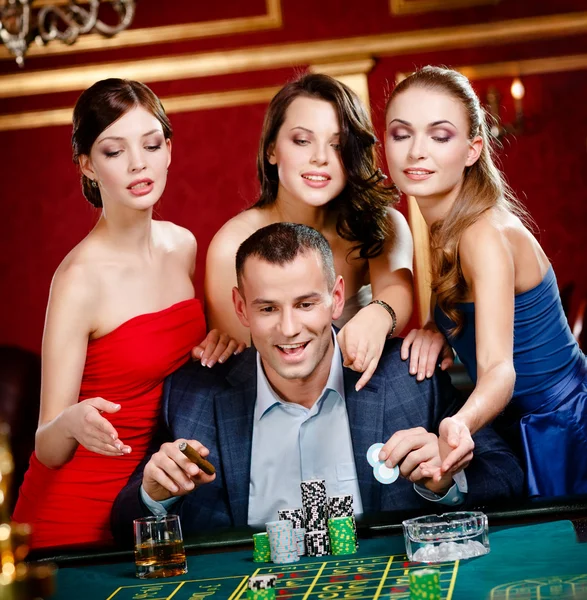 Man surrounded by women gambles roulette Royalty Free Stock Photos