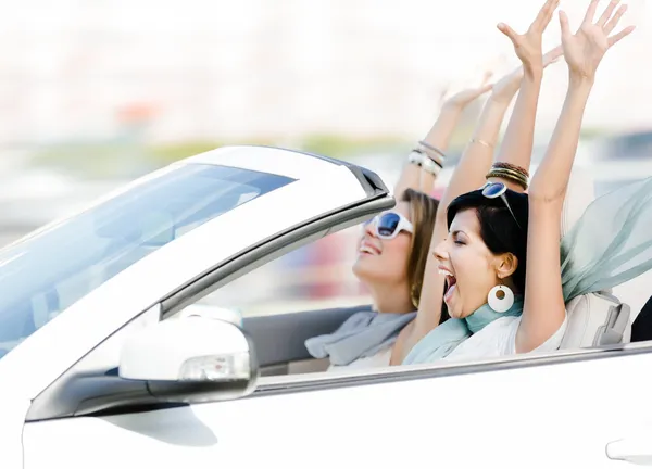 Женщины-друзья в кабриолете с поднятыми руками — стоковое фото