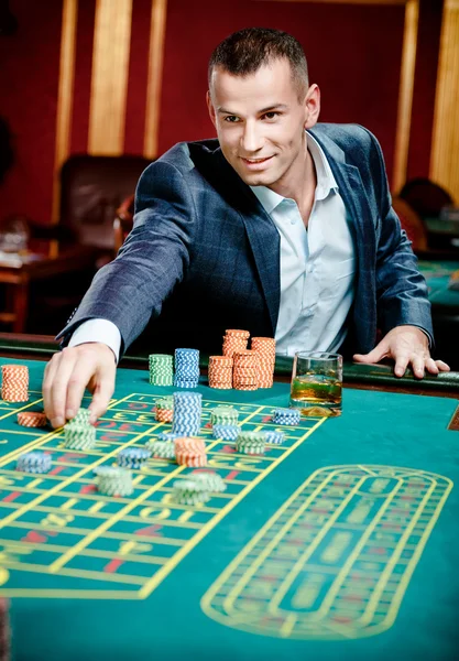 Gambler stakes playing at the casino table — Stock Photo, Image