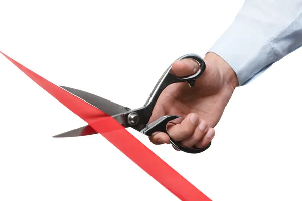 A man cutting a red ribbon — Stock Photo, Image