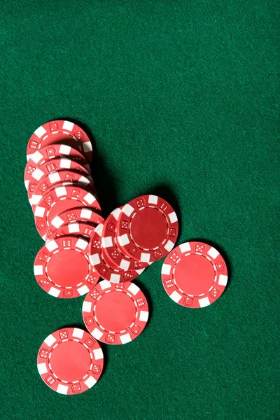 Heap of red poker chips on the green table — Stock Photo, Image