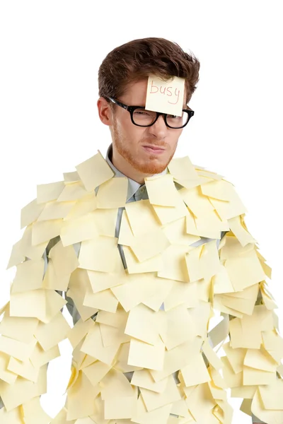 Young man with a sticky note on his face, covered with yellow stickers — Stock Photo, Image