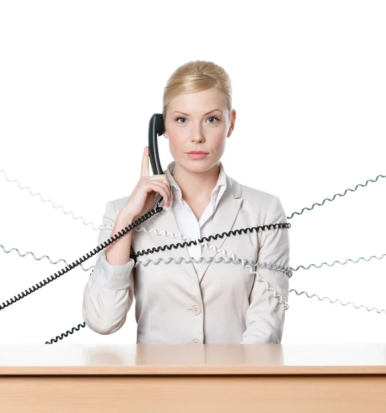 Attractive businesswoman tied with phone wire — Stock Photo, Image