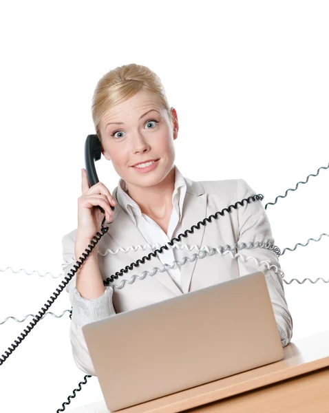 Affärskvinna med laptop bundna med telefon tråd — Stockfoto