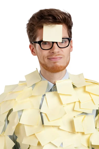 Unhappy young man with a sticky note on his face, covered with stickers — Stock Photo, Image