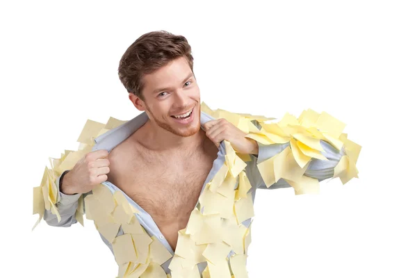A smiling man ripping off his shirt, covered with stickers — Stock Photo, Image