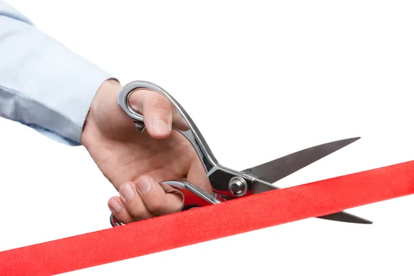 A businessman cutting a red satin ribbon — Stock Photo, Image