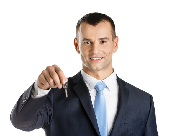 Business man shows key — Stock Photo, Image