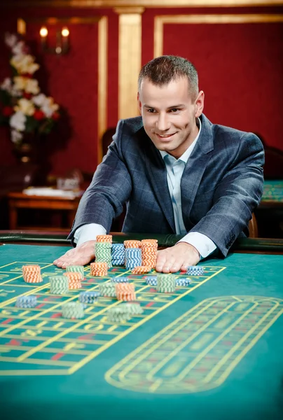 Gambler stakes playing roulette at the casino table — Stock Photo, Image