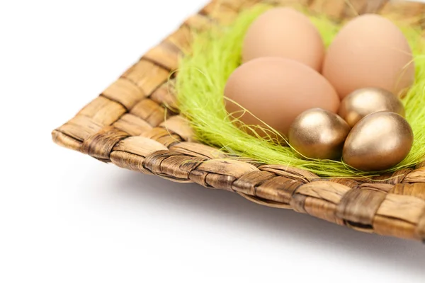 Colorful easter eggs are on wattled plate — Stock Photo, Image