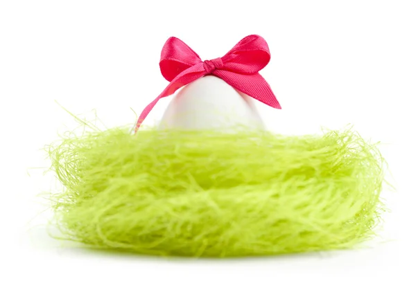 Egg with bow is in the nest of sisal filler — Stock Photo, Image