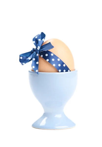 Colored easter egg with blue polka-dotted ribbon — Stock Photo, Image