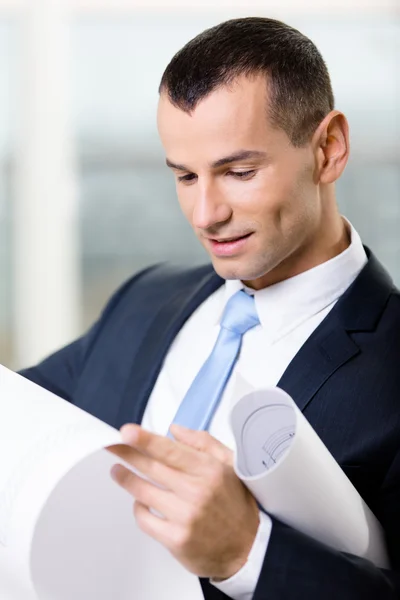 Close up of manager with blueprint — Stock Photo, Image