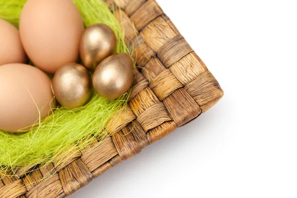 Brown and golden easter eggs are on wattled plate — Stock Photo, Image