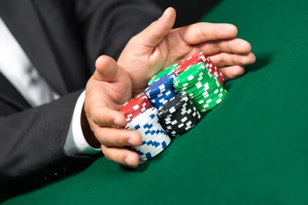 Poker player stakes "all in" pushing his poker chips forward — Stock Photo, Image