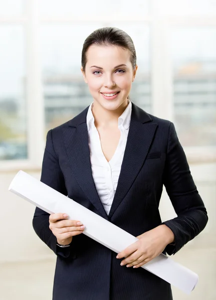 Female engineer with blueprint — Stok fotoğraf