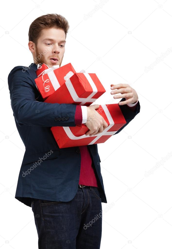 Young man carries a great amount of presents