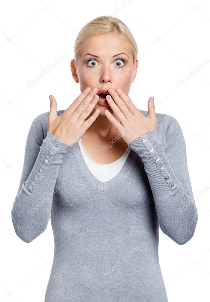 Shocked woman covers mouth with hands