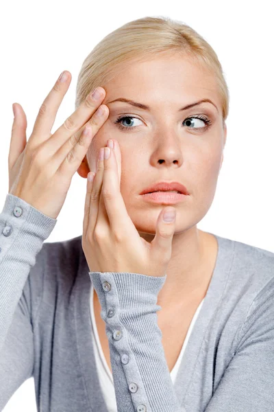 Young girl examining her face — Stock Photo, Image