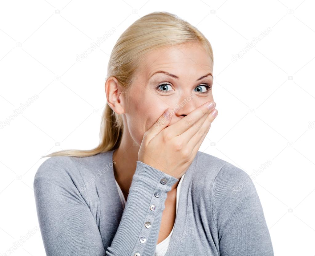 Laughing woman covers mouth with hand