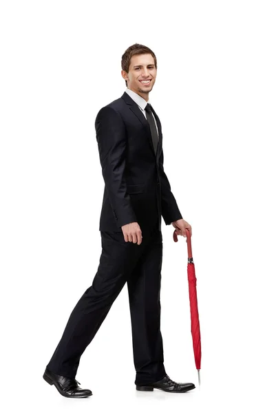 Walking man with closed umbrella — Stock Photo, Image