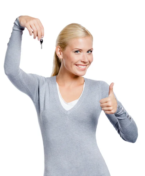 Thumbing up woman keeps key — Stock Photo, Image