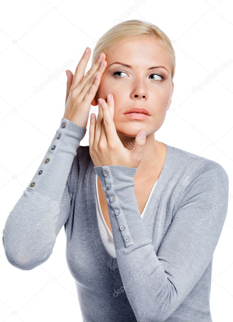 Lady examining her face