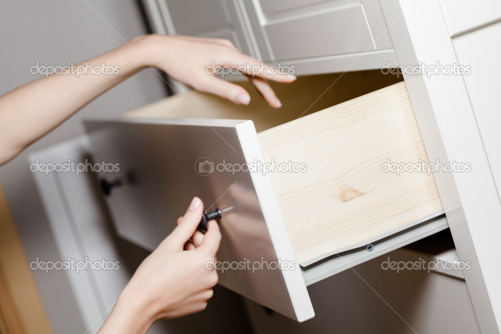 Close up of hand opening a drawer