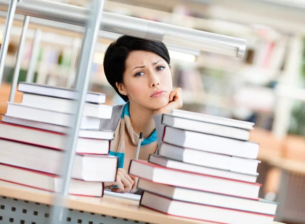 Sad female student over the books — Stock Photo, Image