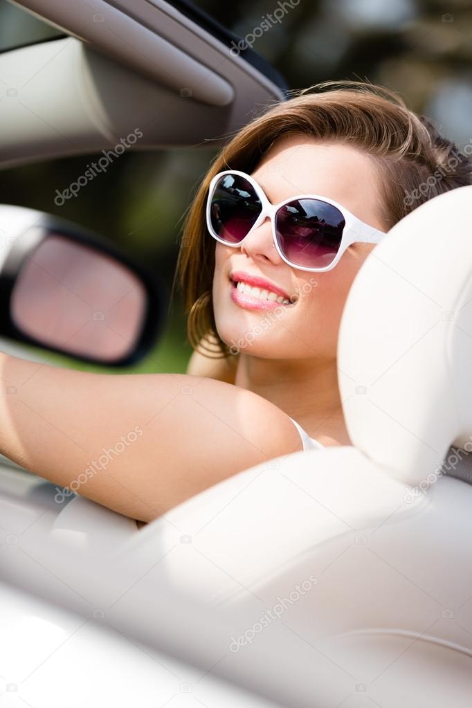 Portrait of pretty woman in the white car