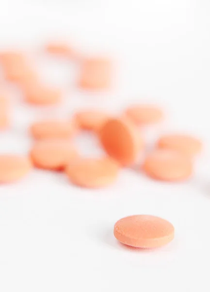 Close up of red colored pills — Stock Photo, Image