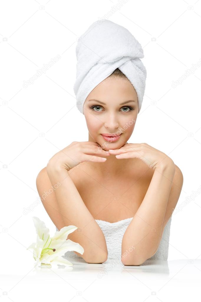 Nude girl with towel on head touches face
