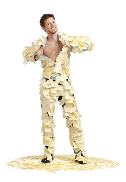 A young man ripping off his shirt, covered with stickers, full-length portrait — Stock Photo, Image