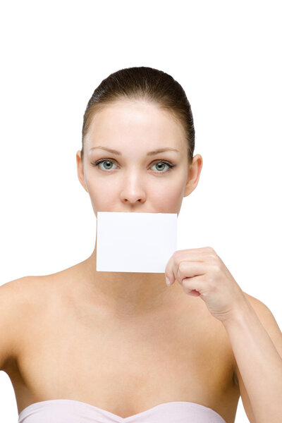 Nude girl keeps copyspace card in front of her mouth