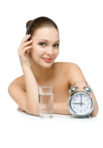 Sexy girl with glass of water and alarm clock — Stock Photo, Image
