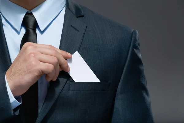 Hombre de negocios saca la tarjeta blanca del bolsillo — Foto de Stock