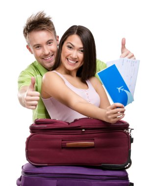 Couple with travel bags and tickets