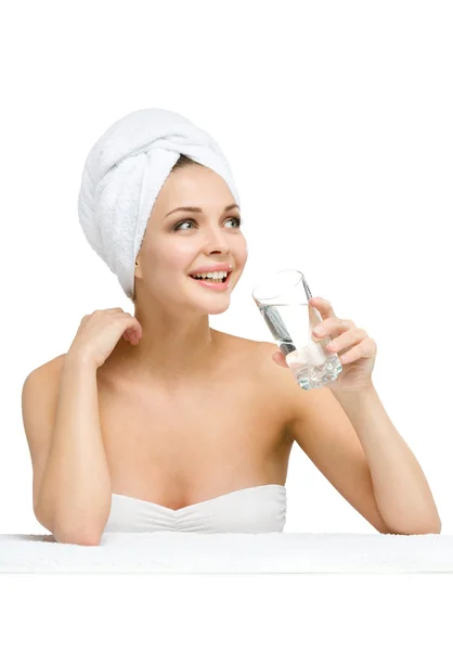 Woman with towel on head drinks water — Stock Photo, Image